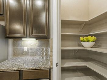 Spacious walk-in pantries with built-in shelves